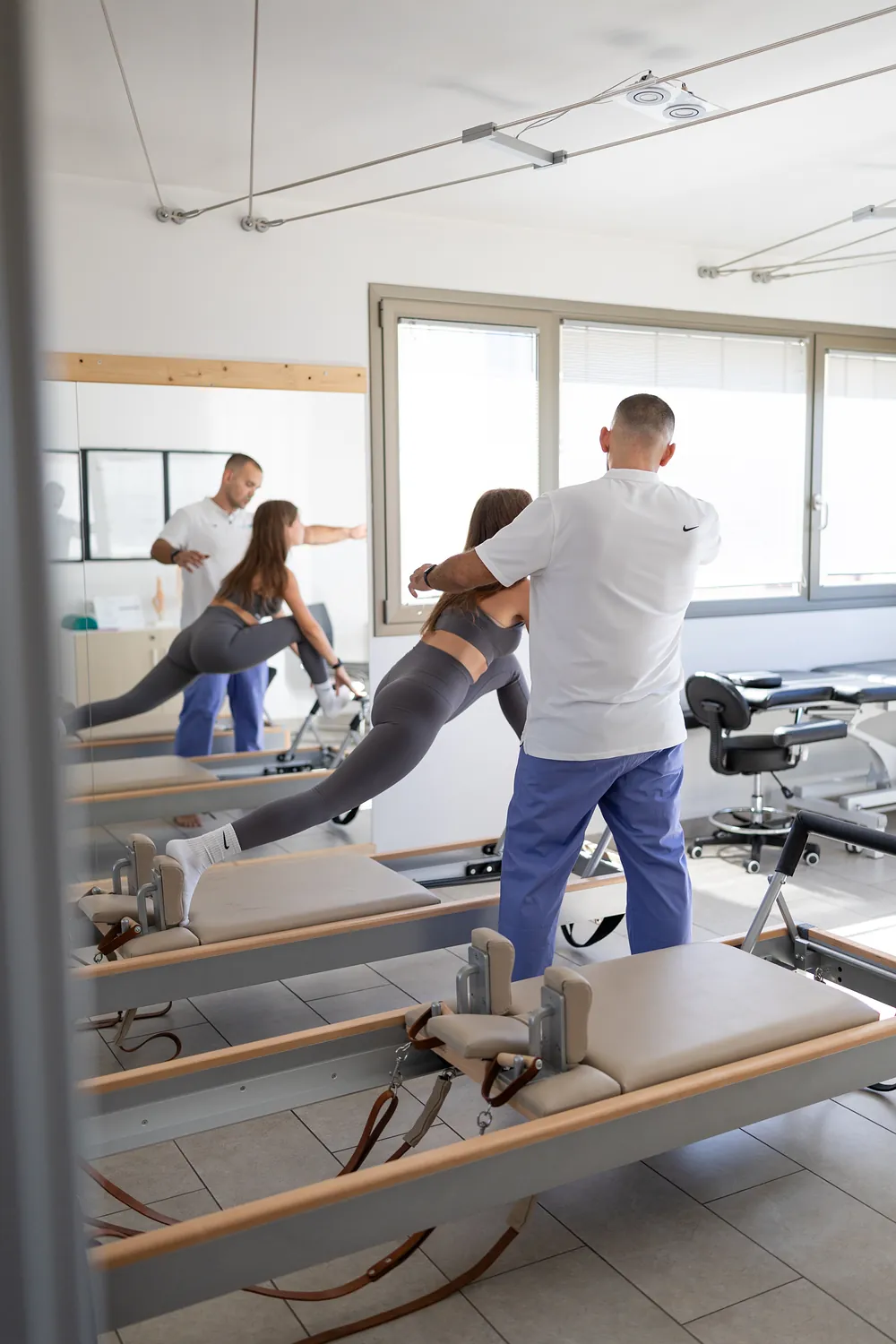 L’insegnante segue un’allieva sul Reformer